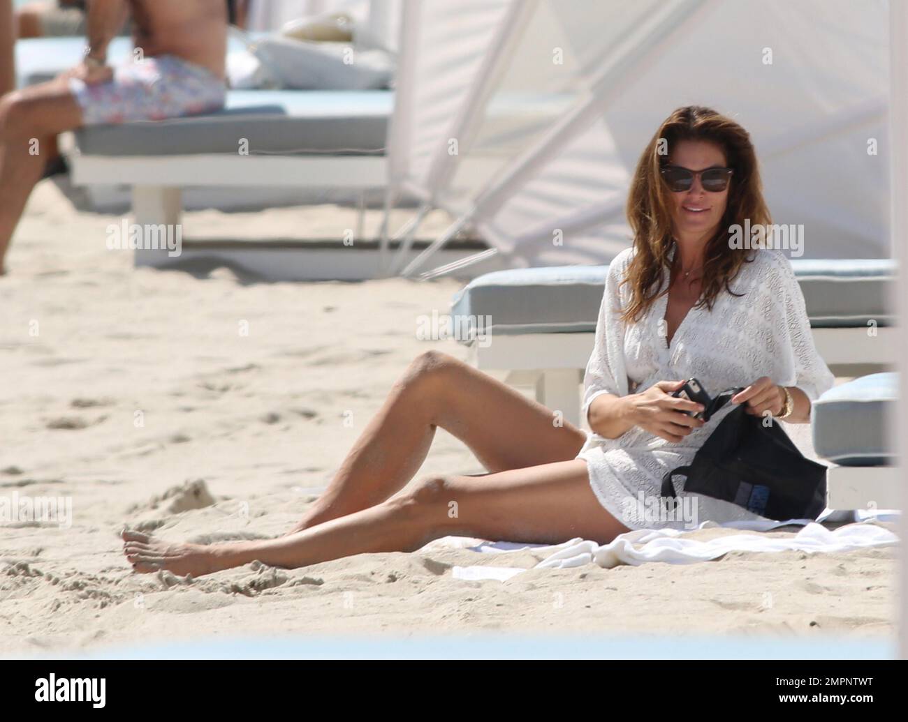 Cindy Crawford gets dressed after an early morning swim in the ocean
