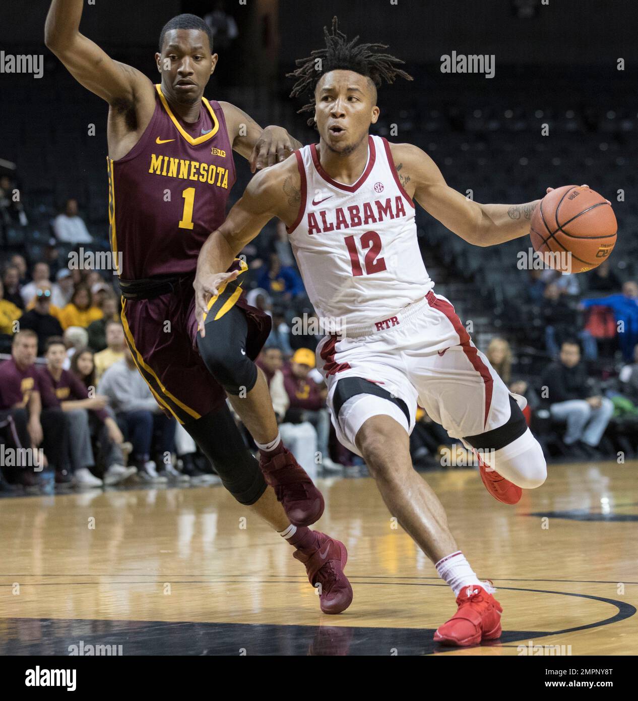 Alabama guard Dazon Ingram (12) drives to the basket against Minnesota