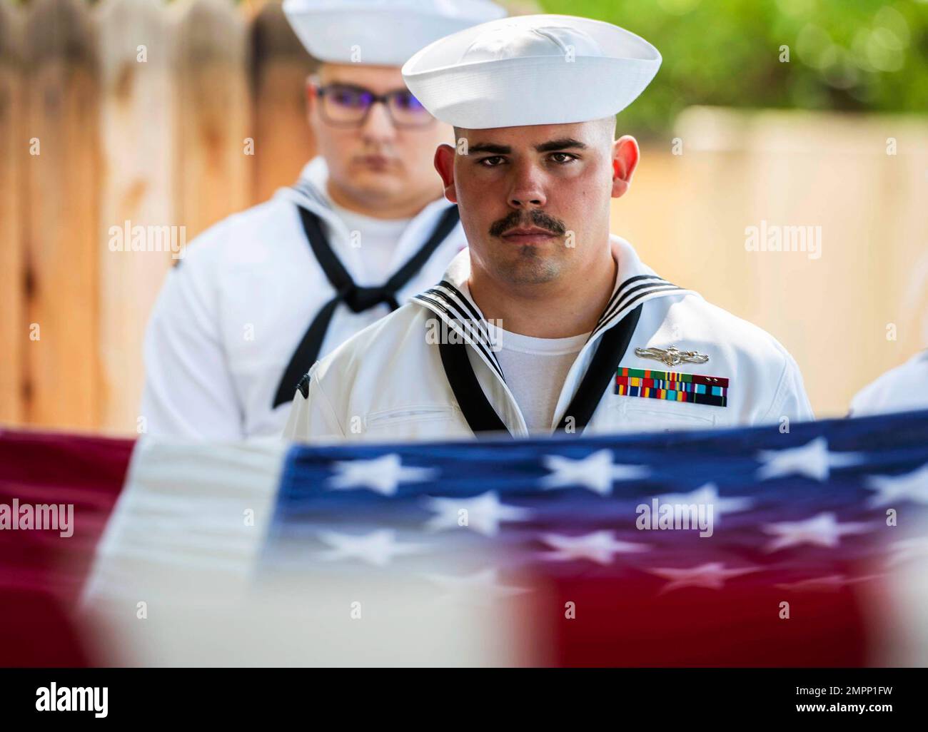 A U.S. Navy Sailor stands at attention during an interment ceremony ...