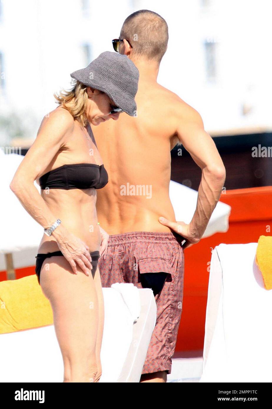 French journalist, romance writer and director of news at TF1, Claire Chazal  wears a black bikini as she relaxes on the beach during a winter holiday  with husband Arnaud Lemaire. Chazal, who