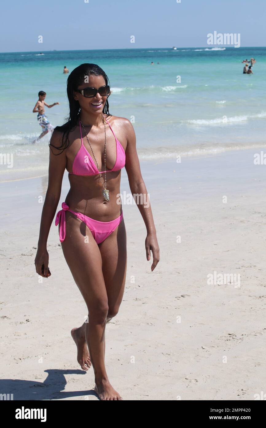 Claudia Jordan is seen showing off her figure in a pink bikini as she  spends the day at the beach with friends and seen taking pictures with  fans. Miami Beach, FL. March