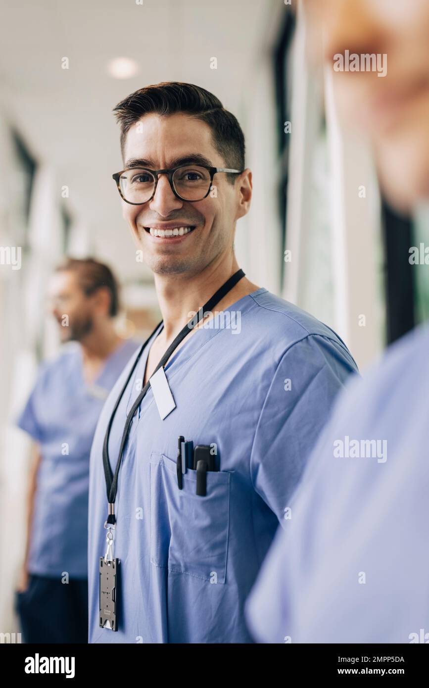 Portrait of happy male healthcare staff wearing eyeglasses at hospital