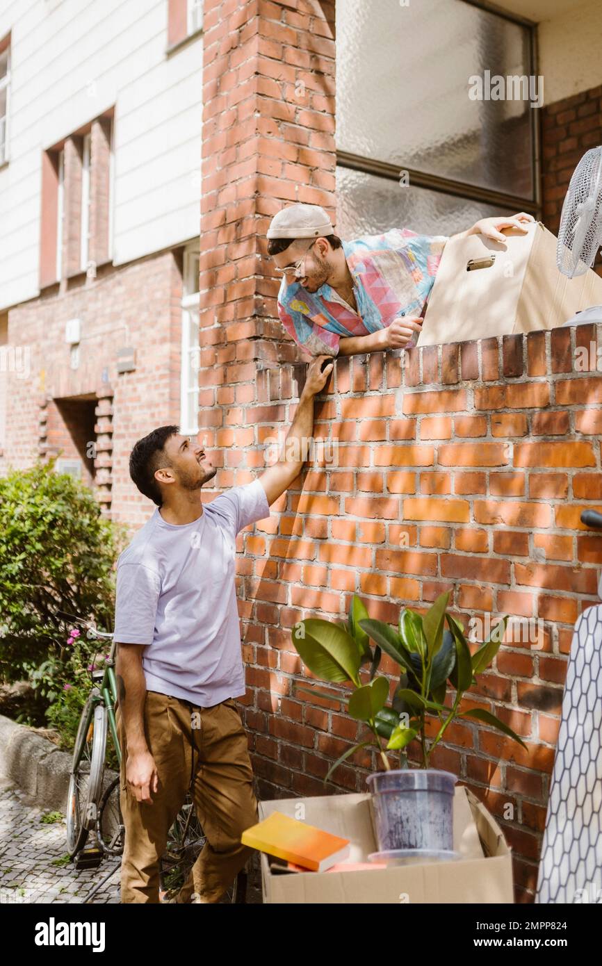 Man leaning on cardboard box hires stock photography and images