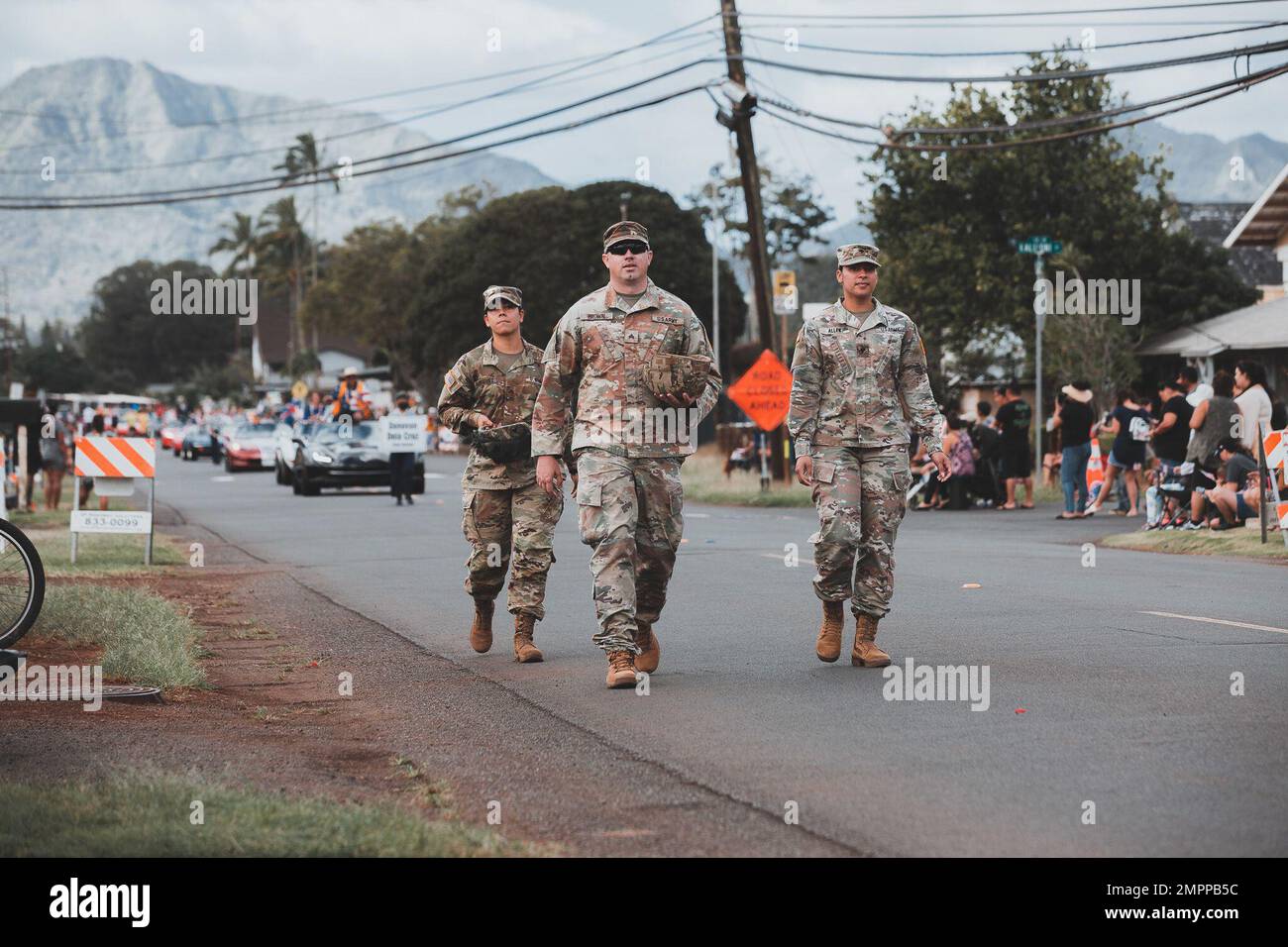 Soldiers assigned to 3rd Infantry Brigade Combat Team, 25th Infantry Division, walk along California Ave. with candy in their helmets to hand out to spectators during the 76th annual Wahiawa Lions Club Veterans Day Parade, in Wahiawa, Nov. 11, 2022. Stock Photo