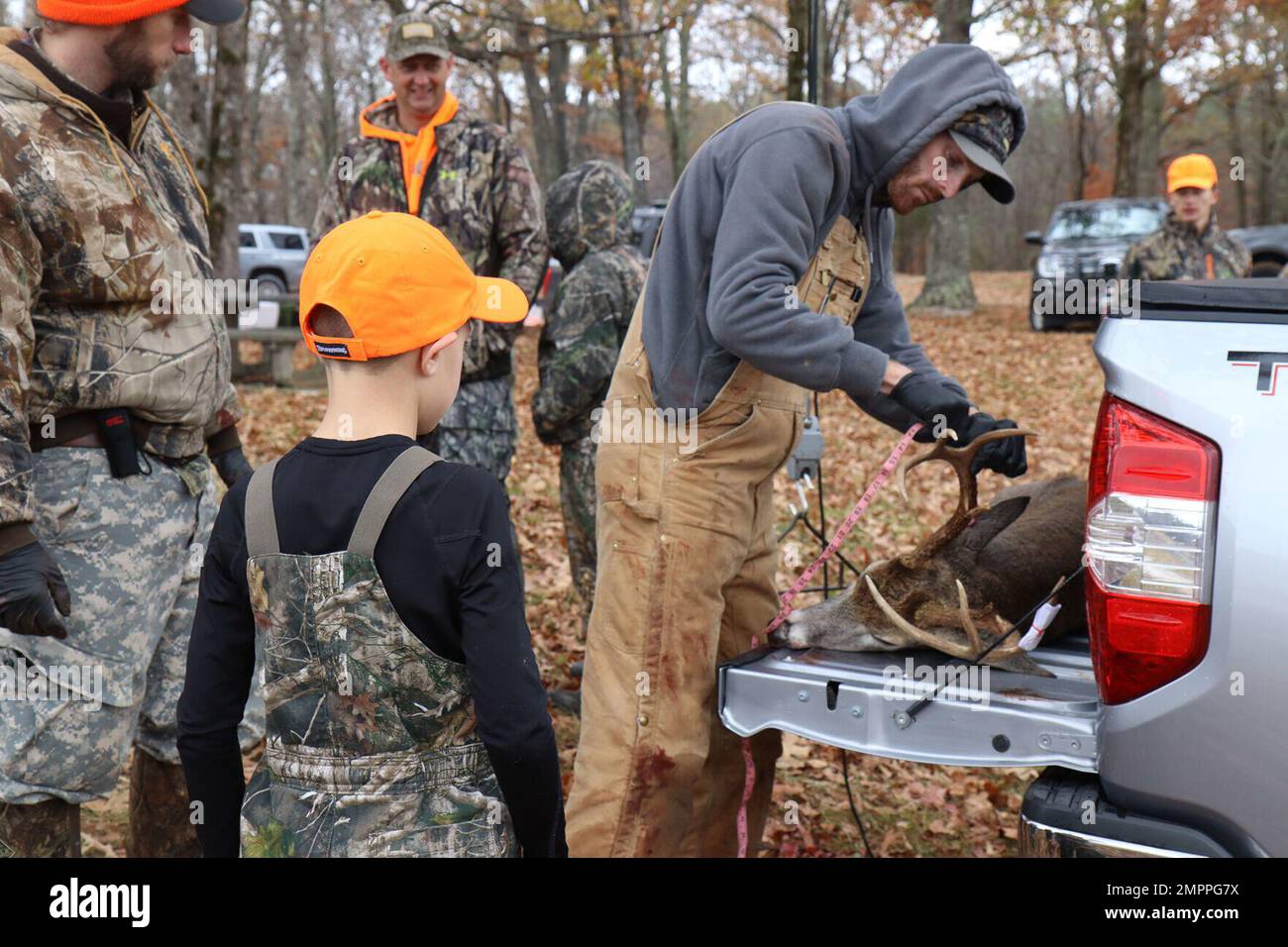 Noah Williams, 9, watches as his buck is measured Nov. 12 during the Fort Campbell Youth Deer Hunt on post. This was Noah’s first time harvesting a buck. Field dressed, it weighed 130 pounds and had an 8-point rack. Stock Photo