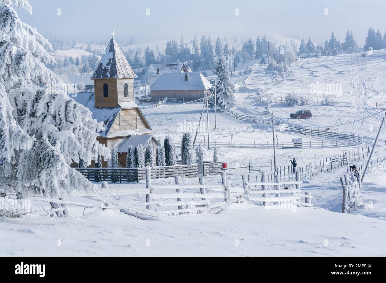 Church Winter fairytale landscape in a mountain village Carpathians Transylvania Romania Stock Photo