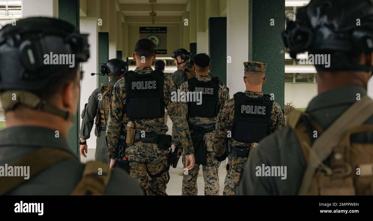 U.S. Marines with Provost Marshal’s Office, Marine Corps Installations Pacific, walk to start training during a simulated bilateral search while participating in Exercise Keen Sword 2023 on Camp Foster, Okinawa, Japan, Nov. 13, 2022. Keen Sword exercises the combined command and control capabilities and lethality developed between MCIPAC, III Marine Expeditionary Force, and the Japan Self-Defense Force. This bilateral field-training demonstrates the U.S. military and JSDF interoperability and combat readiness of the U.S.-Japan Alliance. Stock Photo