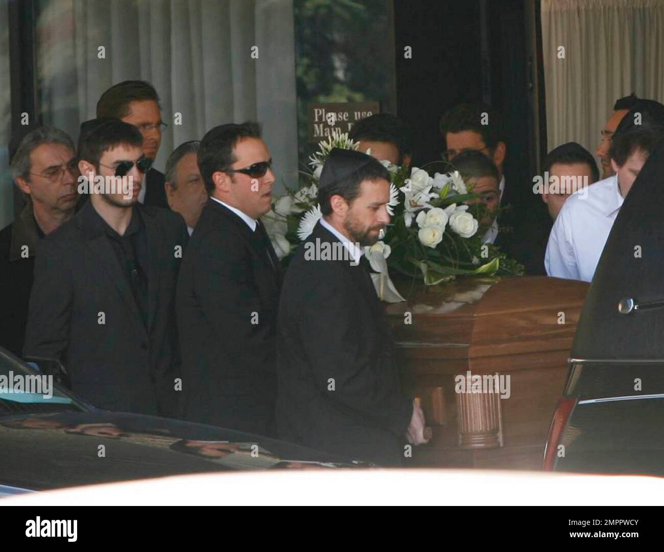 Family and friends gather outside Steeles Memorial Chapel after actor
