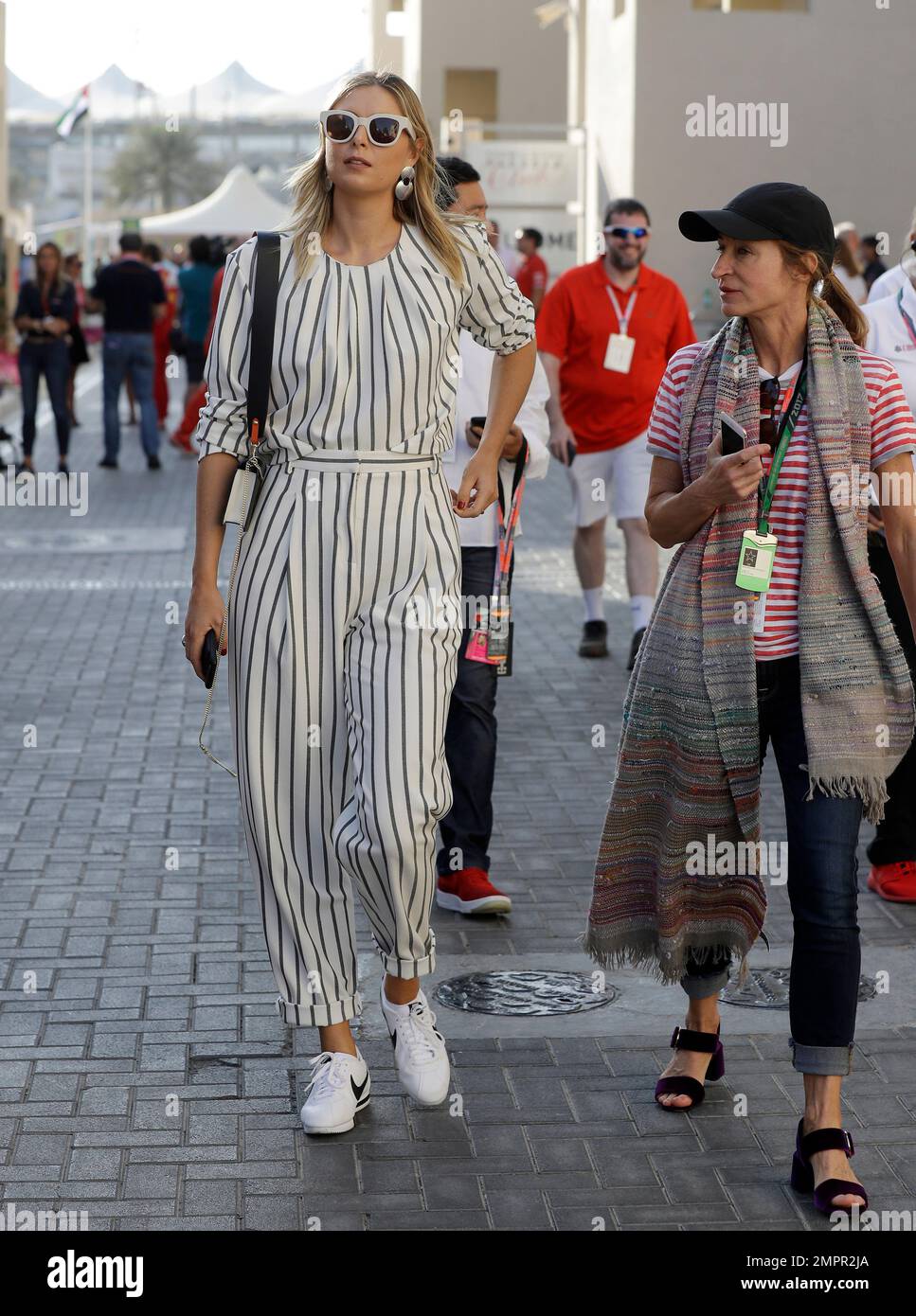Russia's tennis player Maria Sharapova walks through the paddock area of  the Yas Marina racetrack in Abu Dhabi, United Arab Emirates, Saturday, Nov.  25, 2017. The Emirates Formula One Grand Prix will