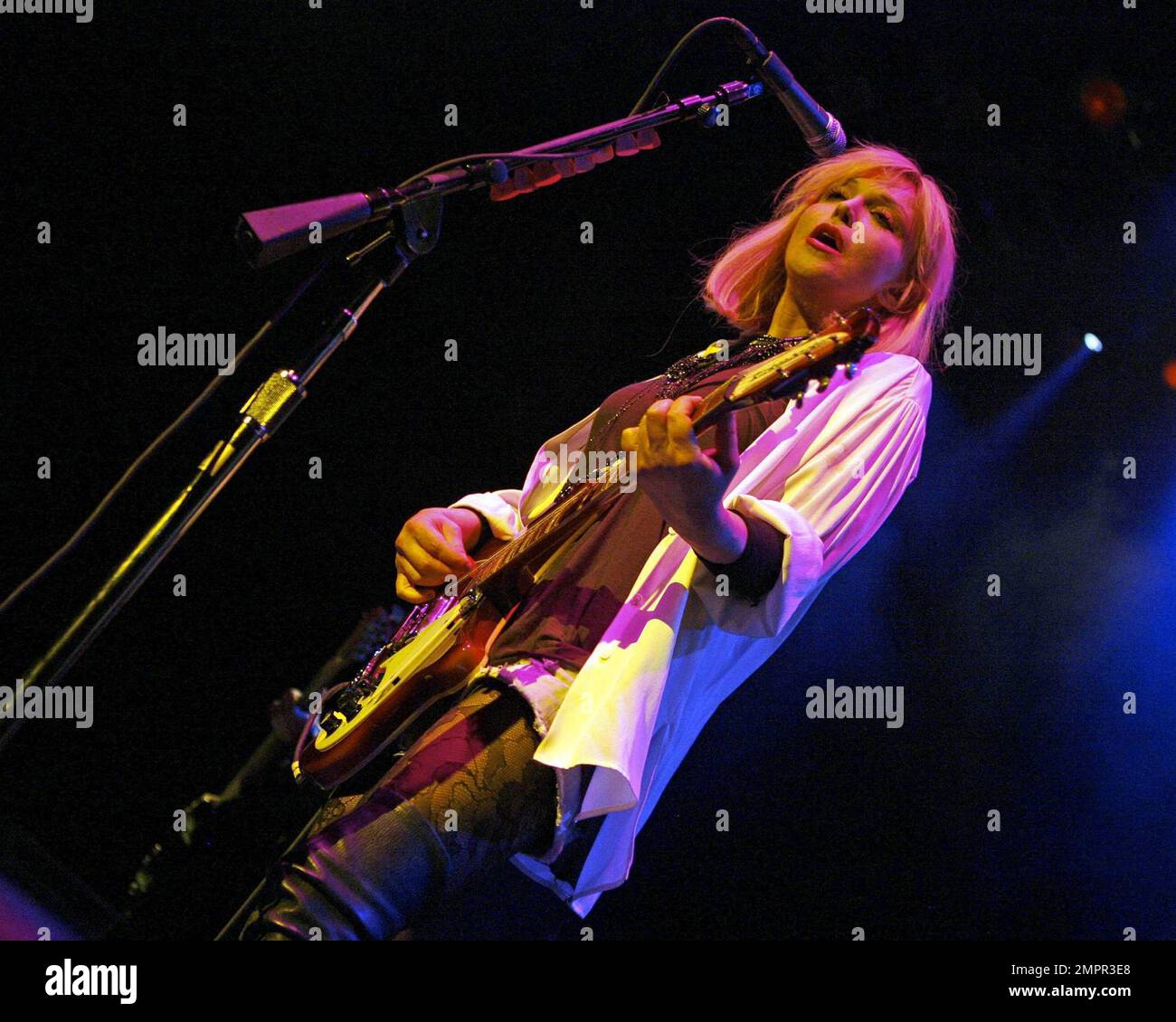 Courtney Love smokes a cigarette on stage as she performs live in ...