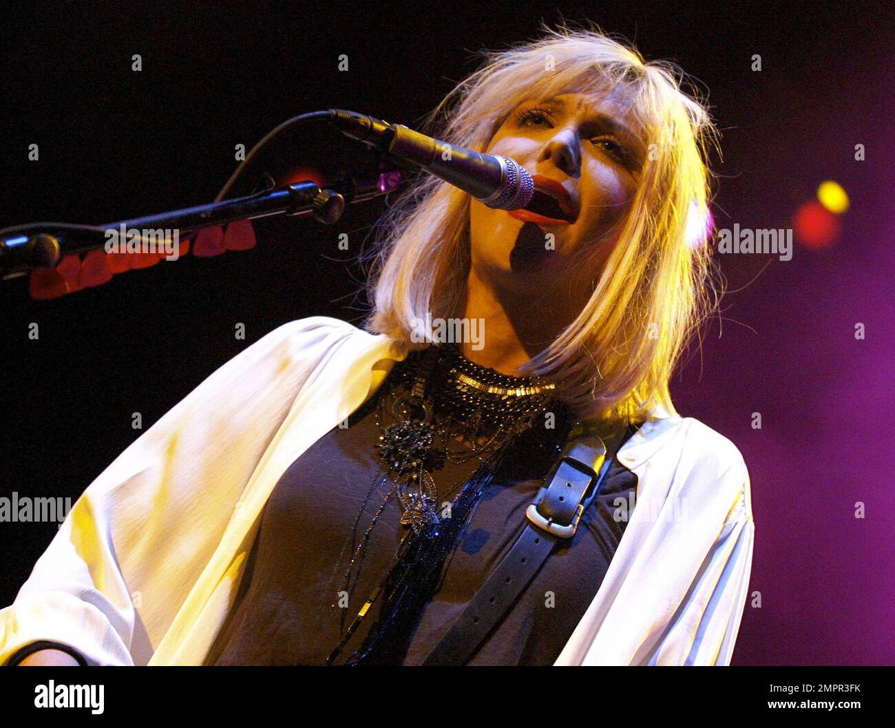 Courtney Love smokes a cigarette on stage as she performs live in ...
