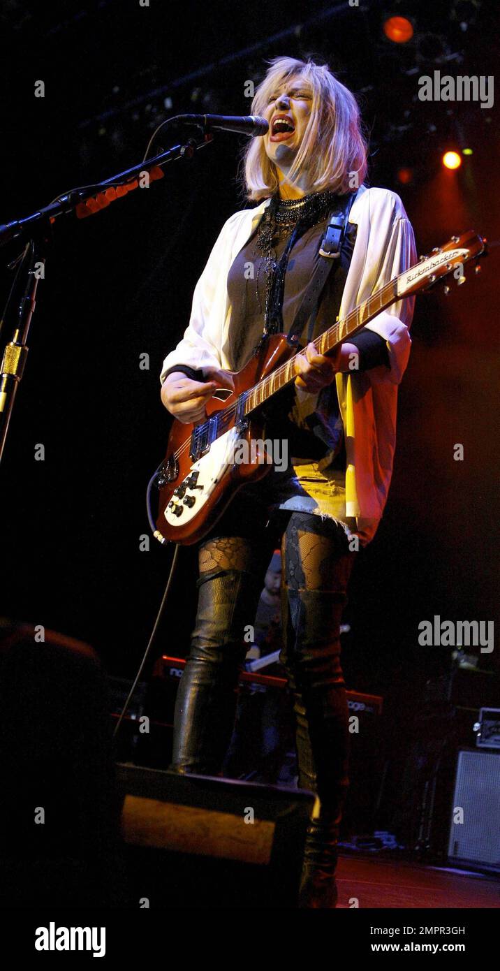 Courtney Love smokes a cigarette on stage as she performs live in ...