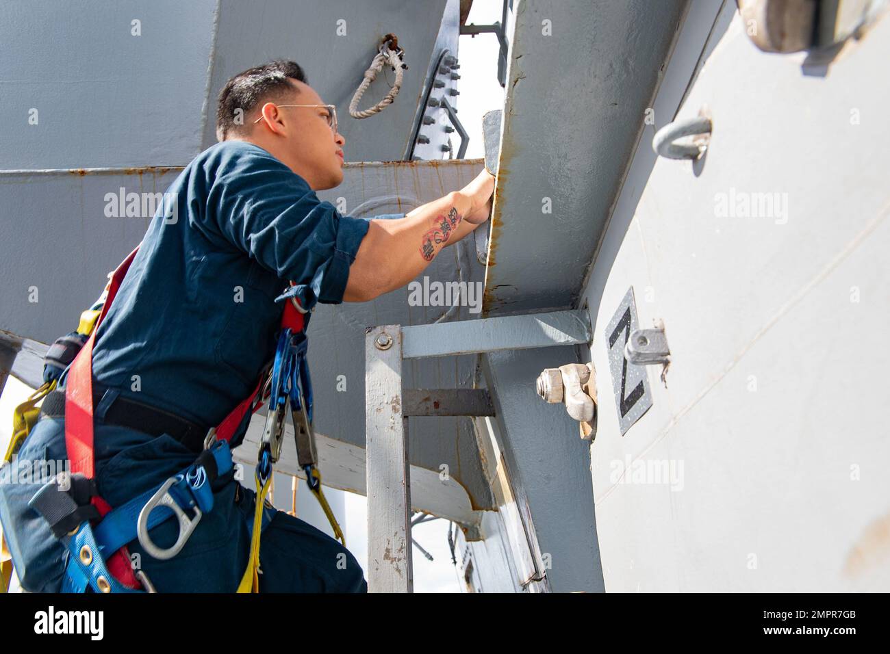 PHILIPPINE SEA (Nov. 15, 2022) Electrician’s Mate 2nd Class Jerome Dedicatoria, from San Diego, prepares to troubleshoot equipment on the mast aboard Arleigh Burke-class guided-missile destroyer USS Milius (DDG 69) while operating in the Philippine Sea, Nov. 15. Milius is assigned to Commander, Task Force 71/Destroyer Squadron (DESRON) 15, the Navy’s largest forward-deployed DESRON and the U.S. 7th Fleet’s principal surface force. Stock Photo