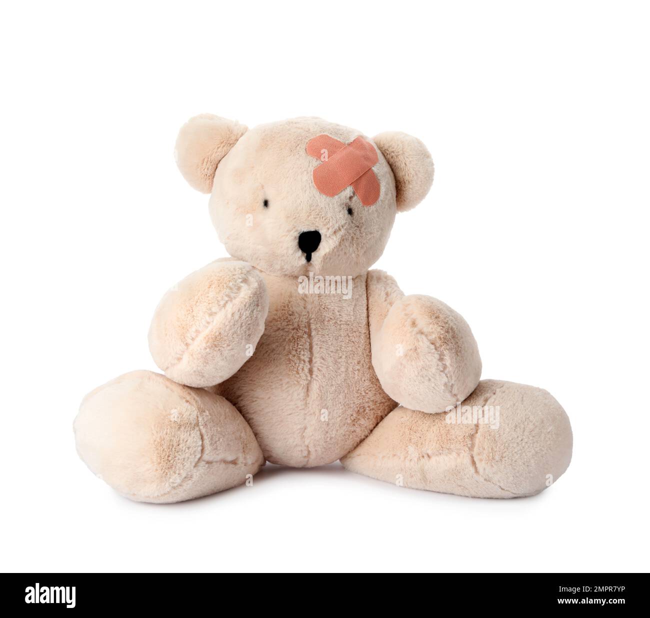 Toy Teddy bear with sticking plasters isolated on white Stock Photo