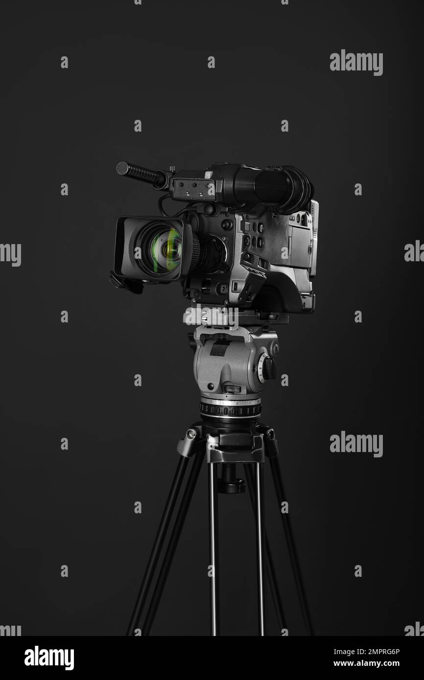 Modern professional video camera on black background Stock Photo Alamy