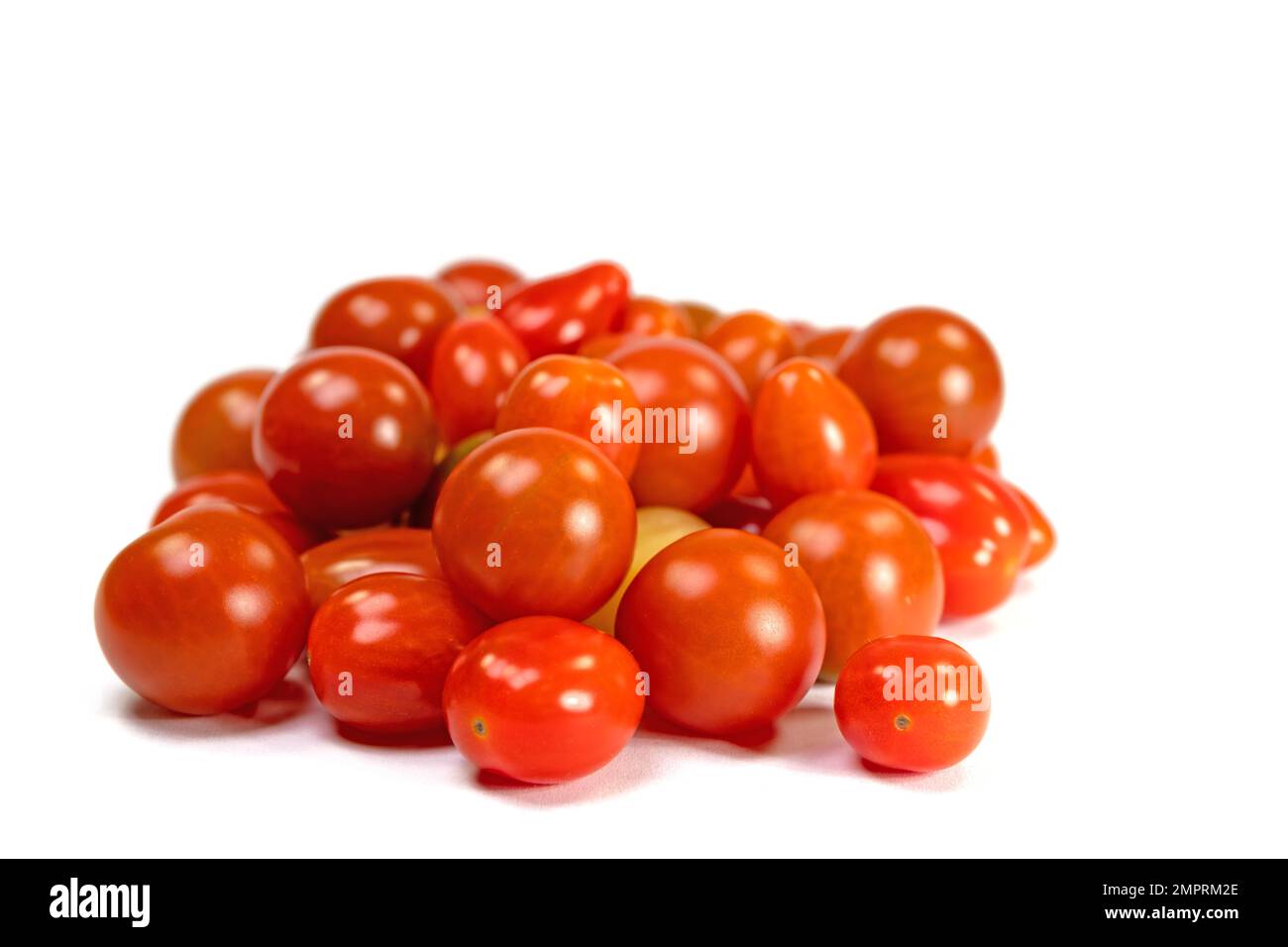 Various mini tomatoes against a white background Stock Photo