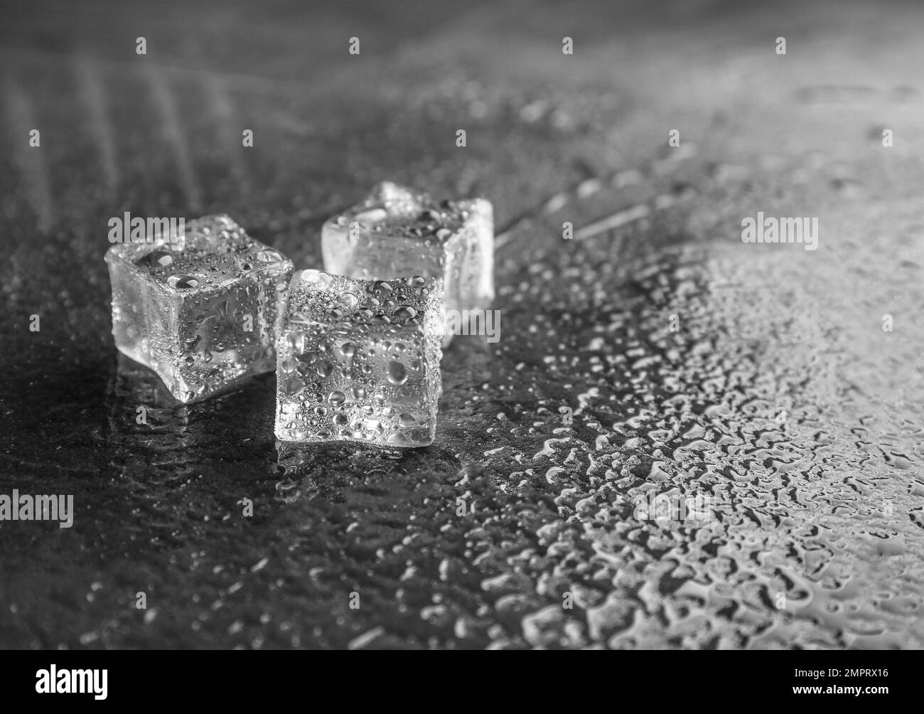 Crystal clear ice cubes on grey stone table. Space for text Stock Photo Alamy