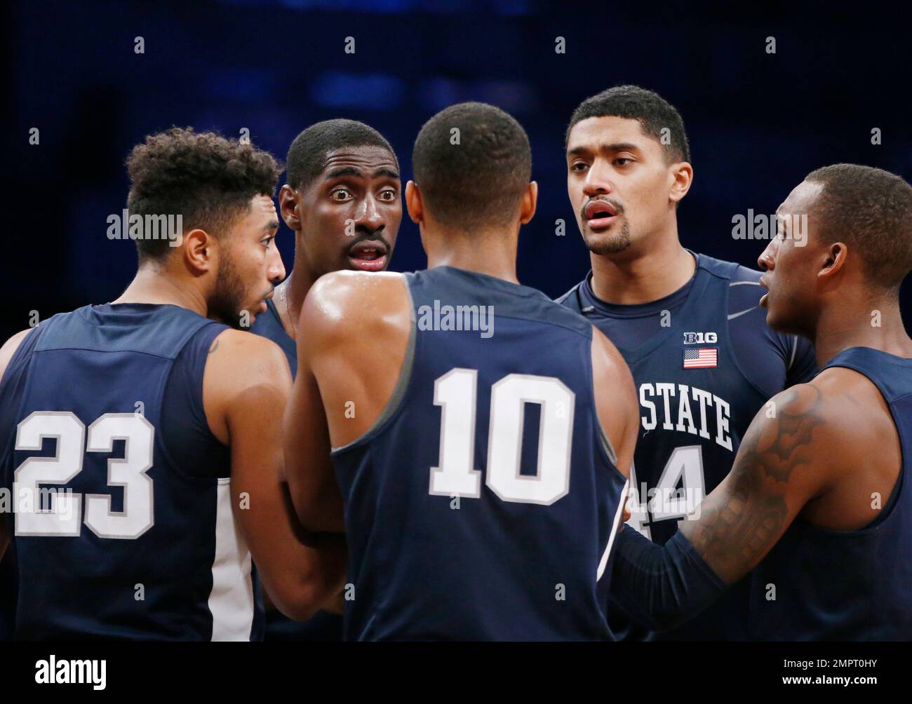 Penn State players gather in a huddle during the second half of an NCAA