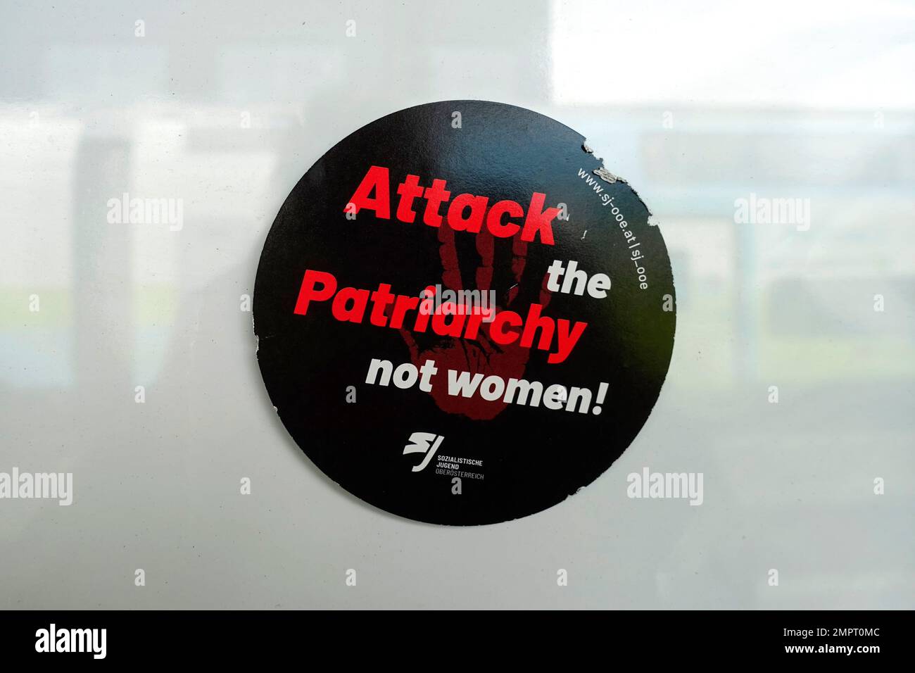 Sticker, attack the patriarchy not women, pubic ground, Salzburg, Austria Stock Photo
