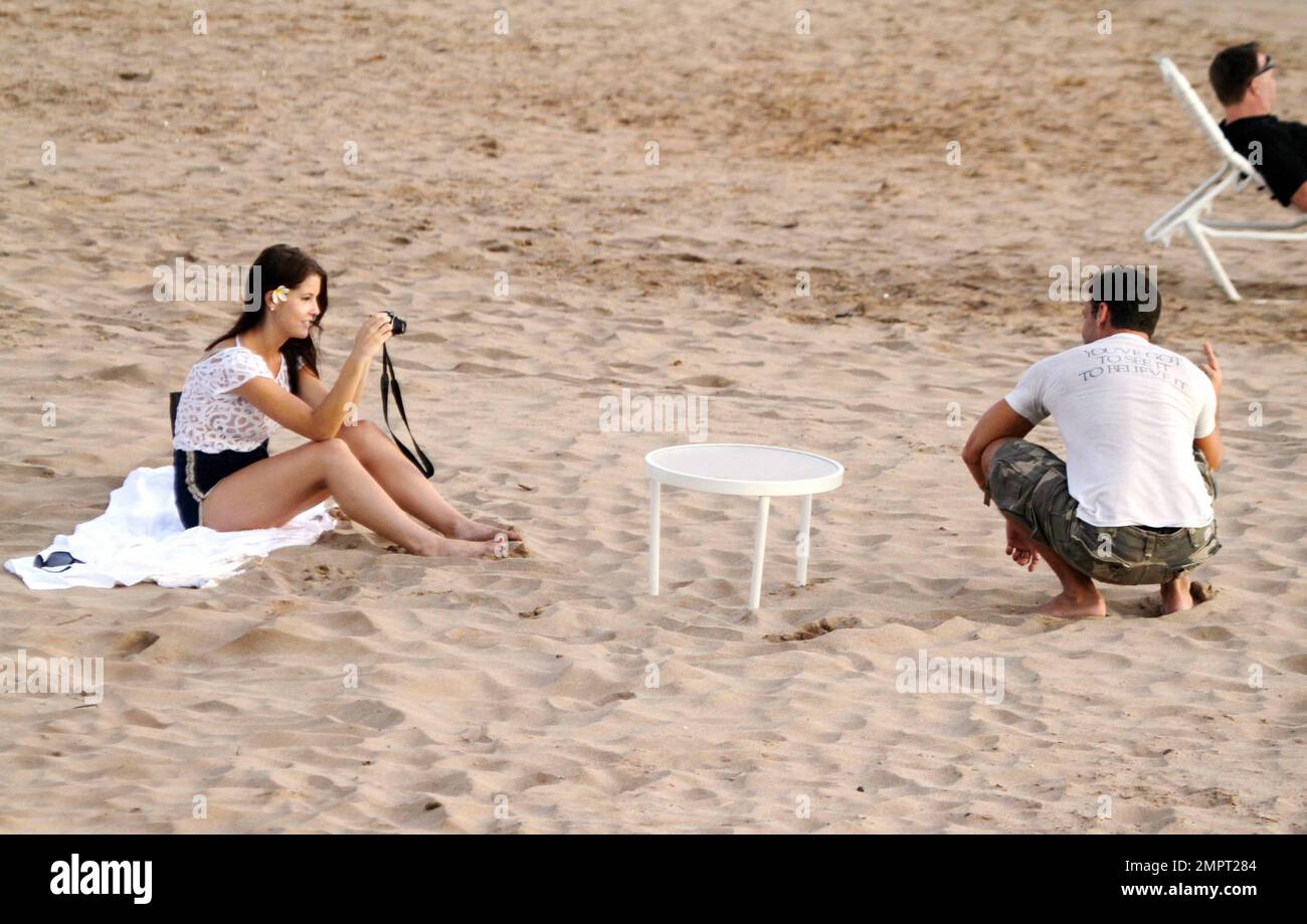 "Hawaii Five-0" star and American comedian Dane Cook spends a romantic evening on the beach at sunset with his reported girlfriend, a beautiful brunette. The two set up a blanket and cuddled by the surf. They also snapped photos of each other, even setting up a table and setting the timer on the camera to take some shots together. Honolulu, HI. 2nd September 2011. Stock Photo