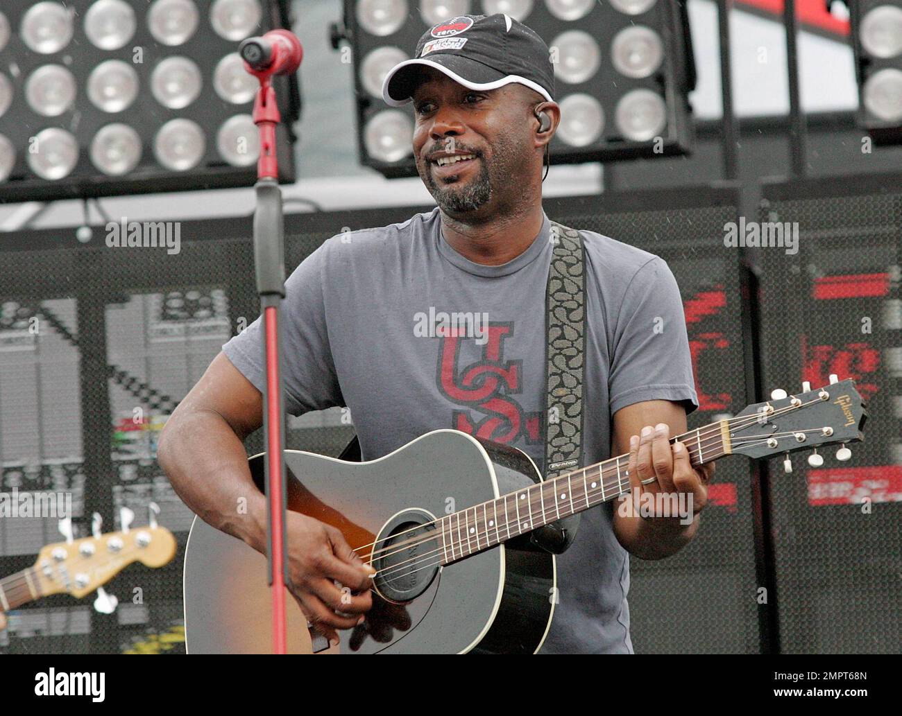Lead singer of Hootie & the Blowfish and CMA New Artist of the Year winner, Darius Rucker performs live in the rain prior to the NASCAR Coke Zero 400 at Daytona International Speedway.  Despite the drizzle the rock-turned-country singer seemed happy as he moved around the stage singing and playing his guitar. Daytona Beach, FL. 07/03/10. Stock Photo