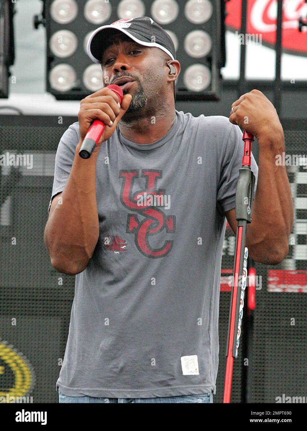 Lead singer of Hootie & the Blowfish and CMA New Artist of the Year winner, Darius Rucker performs live in the rain prior to the NASCAR Coke Zero 400 at Daytona International Speedway.  Despite the drizzle the rock-turned-country singer seemed happy as he moved around the stage singing and playing his guitar. Daytona Beach, FL. 07/03/10. Stock Photo