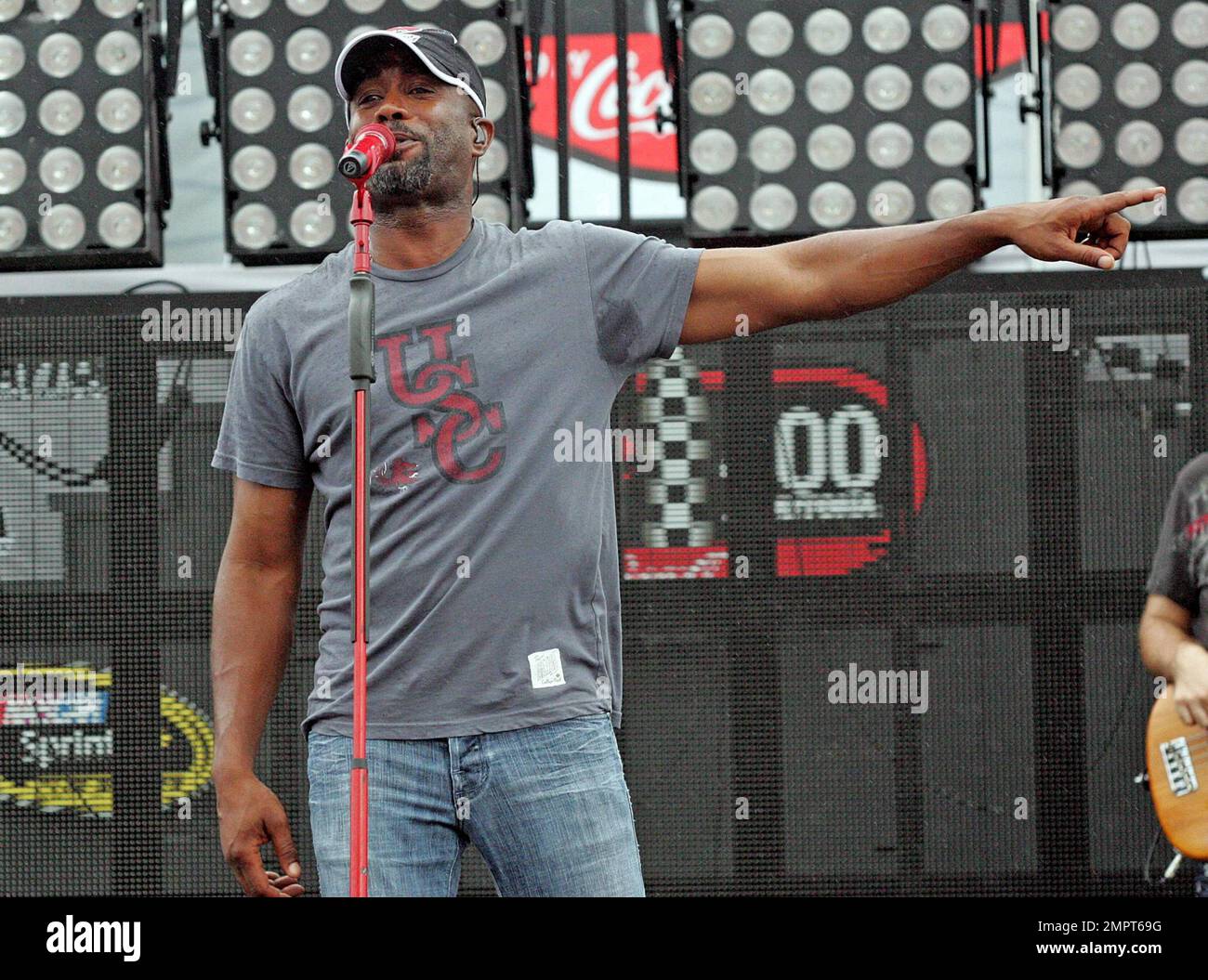 Lead singer of Hootie & the Blowfish and CMA New Artist of the Year winner, Darius Rucker performs live in the rain prior to the NASCAR Coke Zero 400 at Daytona International Speedway.  Despite the drizzle the rock-turned-country singer seemed happy as he moved around the stage singing and playing his guitar. Daytona Beach, FL. 07/03/10.   . Stock Photo