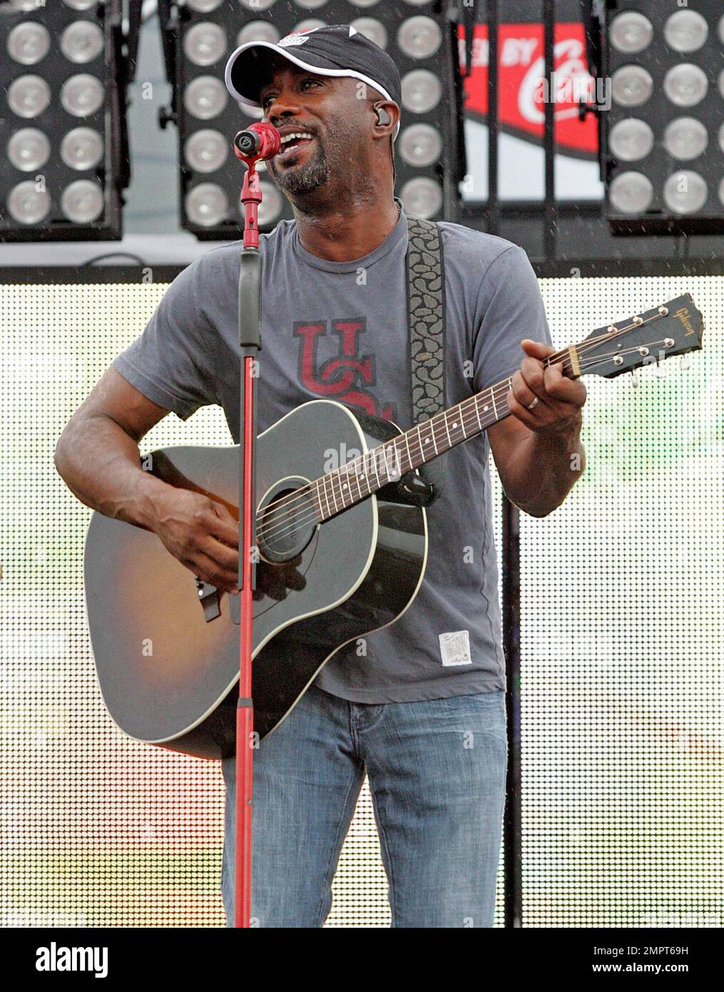 Lead singer of Hootie & the Blowfish and CMA New Artist of the Year winner, Darius Rucker performs live in the rain prior to the NASCAR Coke Zero 400 at Daytona International Speedway.  Despite the drizzle the rock-turned-country singer seemed happy as he moved around the stage singing and playing his guitar. Daytona Beach, FL. 07/03/10.   . Stock Photo