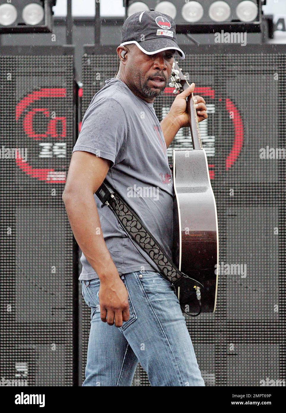 Lead singer of Hootie & the Blowfish and CMA New Artist of the Year winner, Darius Rucker performs live in the rain prior to the NASCAR Coke Zero 400 at Daytona International Speedway.  Despite the drizzle the rock-turned-country singer seemed happy as he moved around the stage singing and playing his guitar. Daytona Beach, FL. 07/03/10.   . Stock Photo