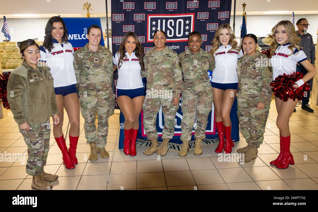 Soldiers from the 75th Innovation Command, U.S. Army Reserve, stand shoulder-to-shoulder with Houston Texans cheerleaders during a Salute to Service luncheon Nov. 17, 2022, at Joint Reserve Base Ellington Field, Texas. The Soldiers joined dozens of fellow service members for a complimentary sandwiches and side items prepared by Killen's BBQ and served by former Houston Texans players and current cheerleaders. The event showcased the NFL's support for service members and its partnership with the event's organizers at USO Houston. Stock Photo