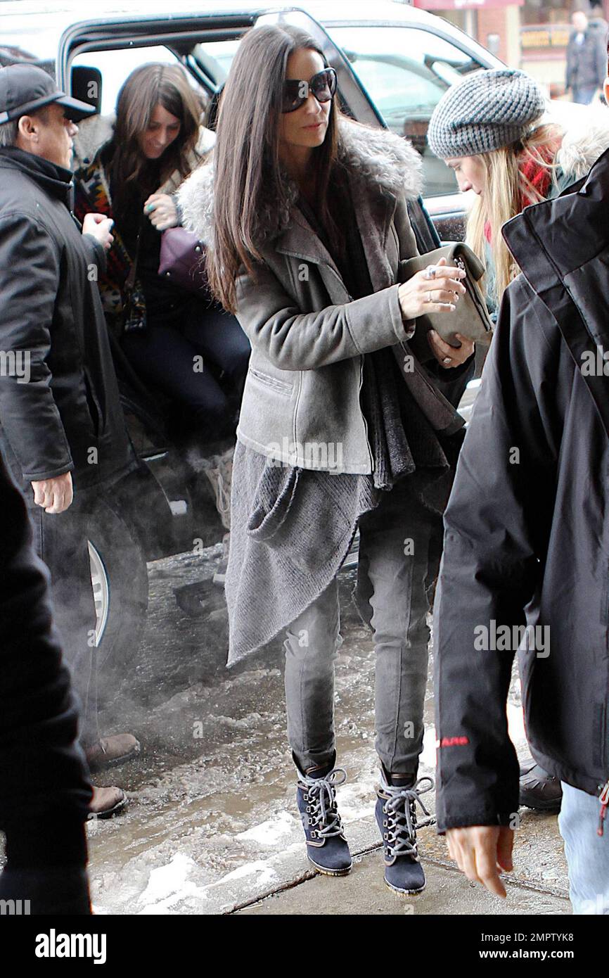 Demi Moore keeps warm in a grey jacket, jeans and lace-up boots