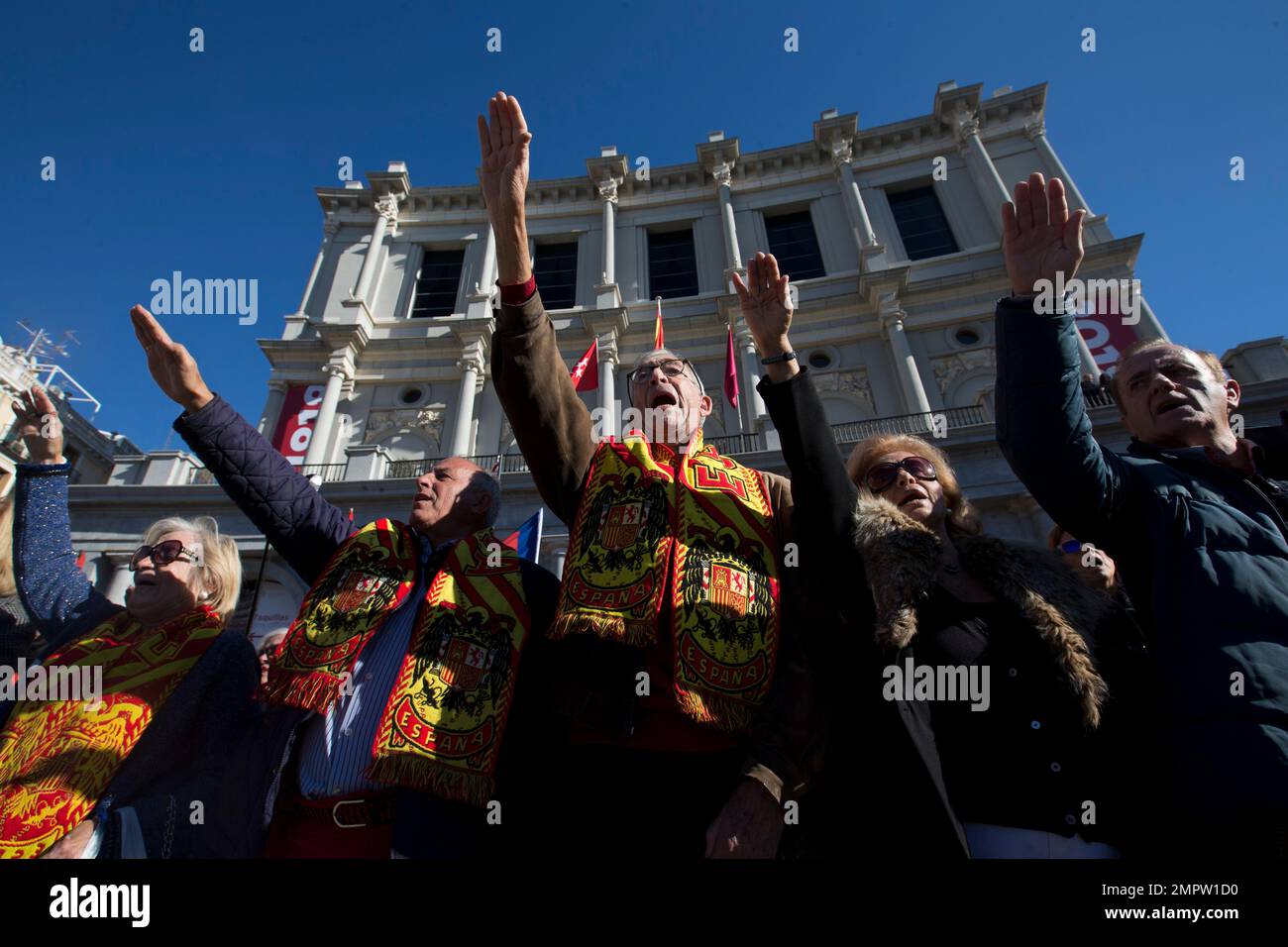 People give stiff arm salutes during an event to commemorate Spanish