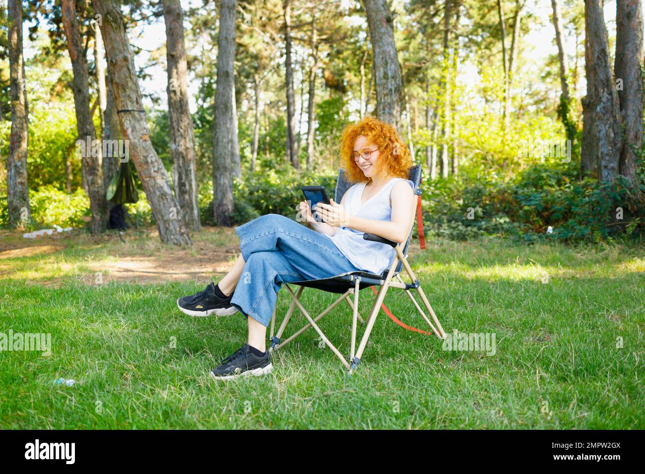 Young woman resting in nature and reading Stock Photo