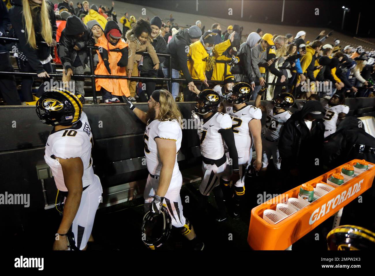 Missouri players celebrate with fans after beating Vanderbilt in an