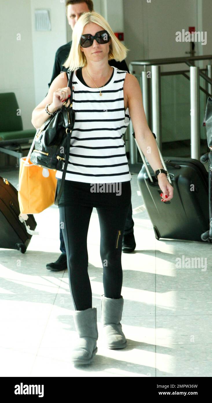 UK TV personality Denise van Outen shows off her new tan as she arrives at  Heathrow airport from Dubai after enjoying a vacation there. Wearing a  striped top and zipper detailed leggings