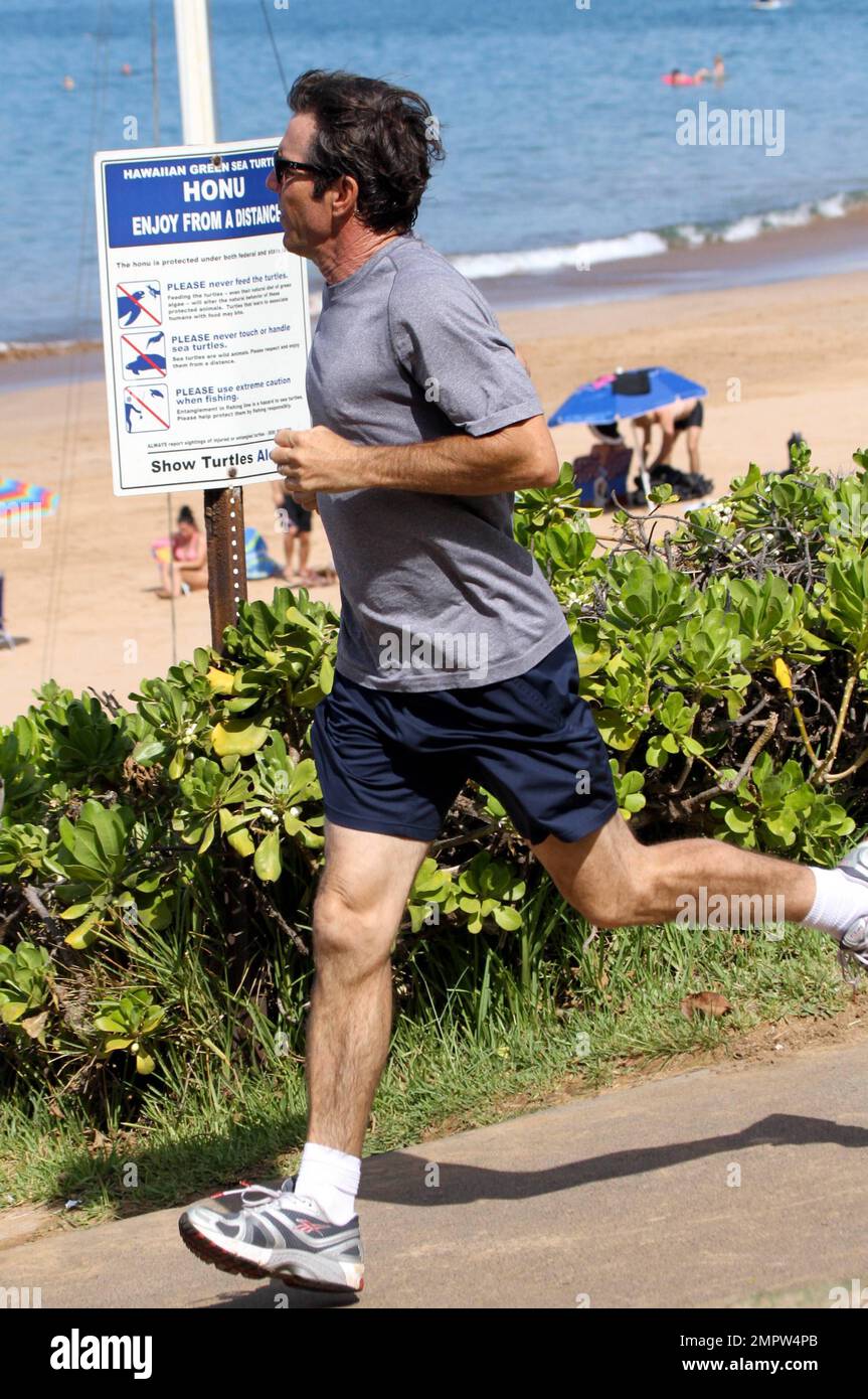 Hunky actor Dennis Quaid and wife Kimberly Buffington keep up their fit physiques with a jog during a Hawaiian holiday. Quaid, who reportedly put his Montana ranch up for sale earlier this week, recently said he dreams of moving to Hawaii to spend more time surfing. The 57-year-old 'Footloose' star first came to love surfing when filming the movie 'Soul Surfer,' which tells the story of shark attack victim Bethany Hamilton. Maui, HI. 26th October 2011.    . Stock Photo