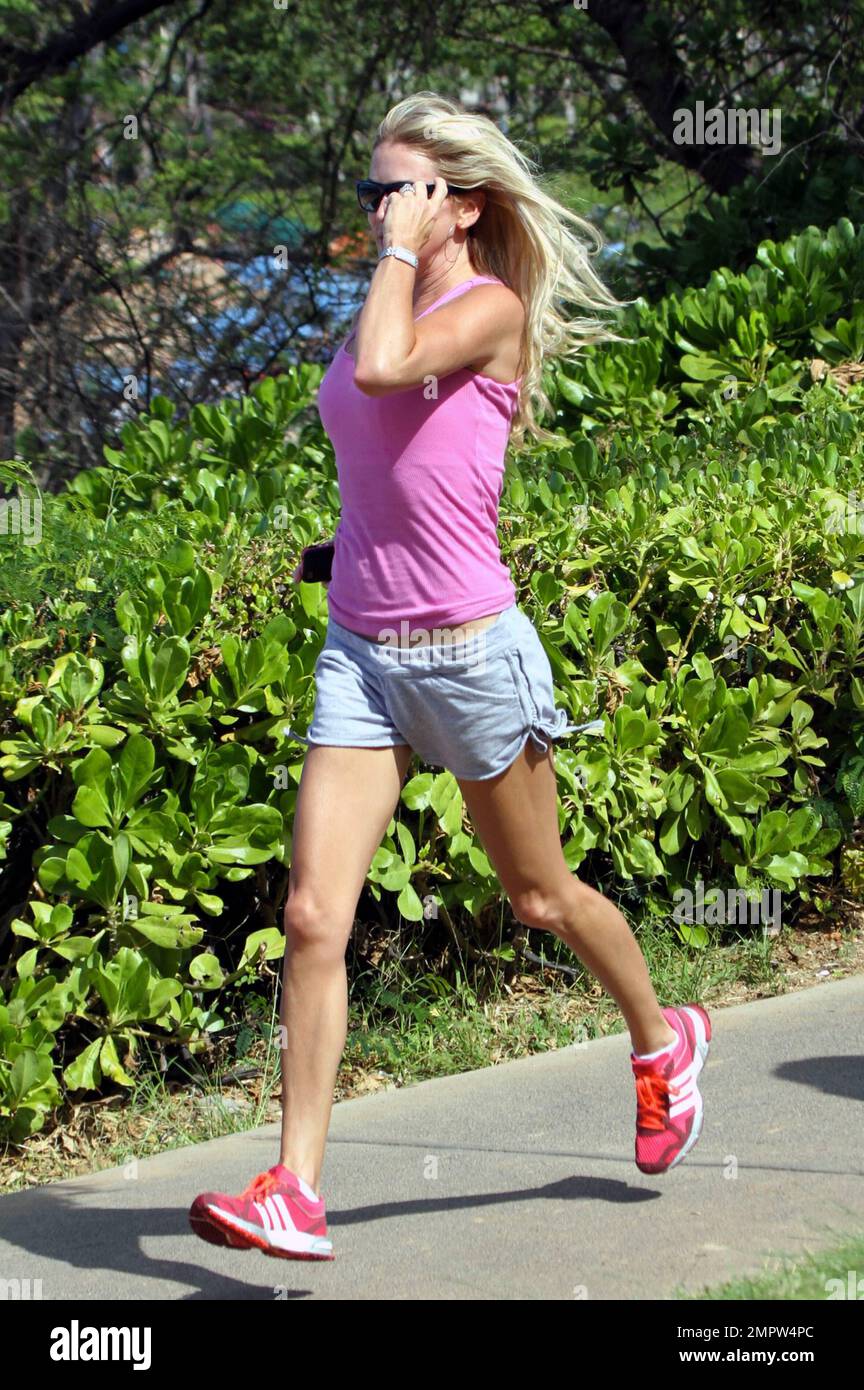 Hunky actor Dennis Quaid and wife Kimberly Buffington keep up their fit physiques with a jog during a Hawaiian holiday. Quaid, who reportedly put his Montana ranch up for sale earlier this week, recently said he dreams of moving to Hawaii to spend more time surfing. The 57-year-old 'Footloose' star first came to love surfing when filming the movie 'Soul Surfer,' which tells the story of shark attack victim Bethany Hamilton. Maui, HI. 26th October 2011.    . Stock Photo