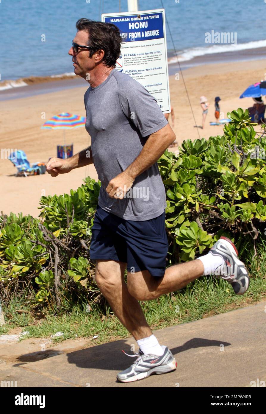 Hunky actor Dennis Quaid and wife Kimberly Buffington keep up their fit physiques with a jog during a Hawaiian holiday. Quaid, who reportedly put his Montana ranch up for sale earlier this week, recently said he dreams of moving to Hawaii to spend more time surfing. The 57-year-old 'Footloose' star first came to love surfing when filming the movie 'Soul Surfer,' which tells the story of shark attack victim Bethany Hamilton. Maui, HI. 26th October 2011.   . Stock Photo