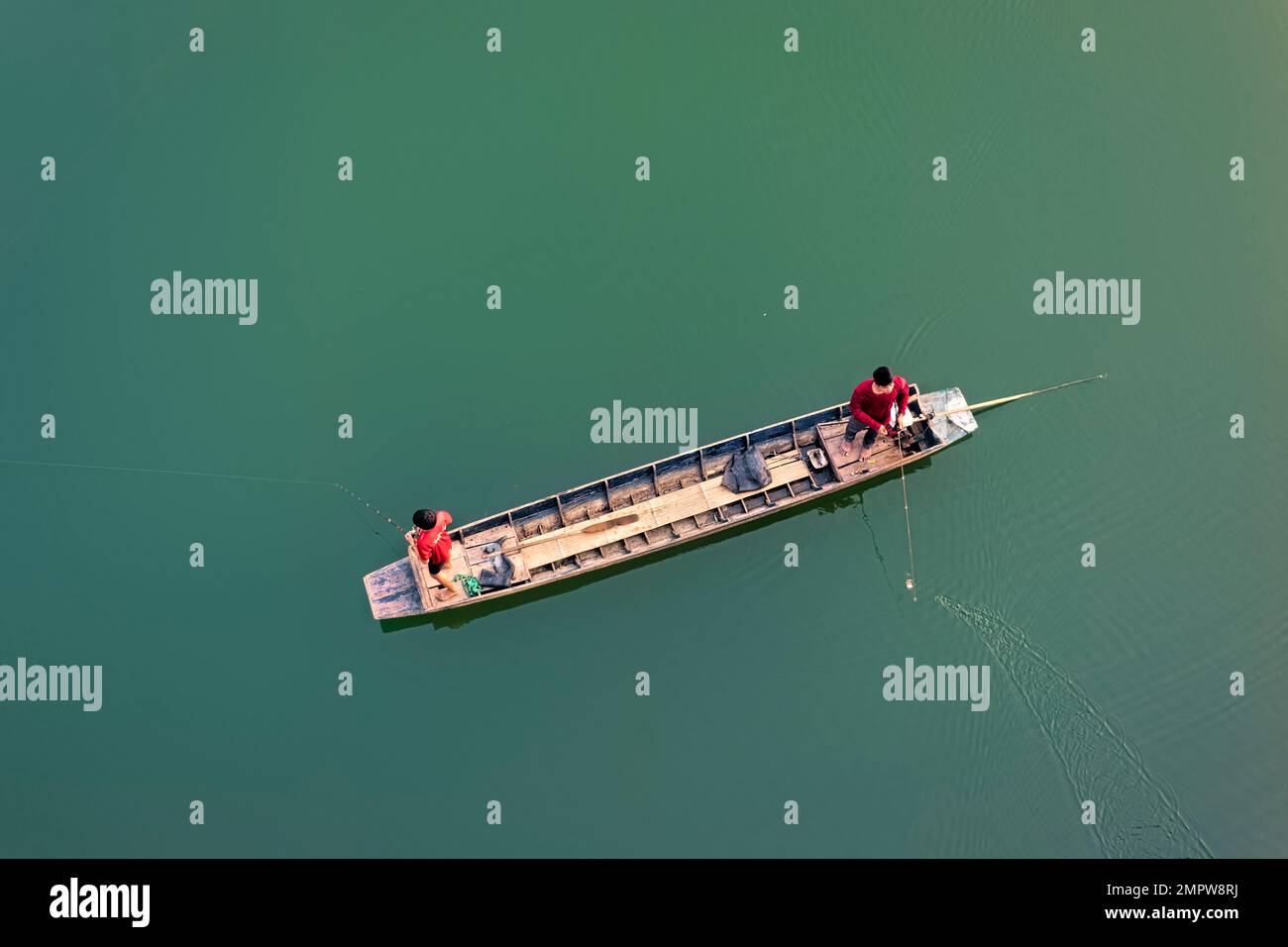 Boys fishing on Vajiralongkorn Lake, Sangkhlaburi, Thailand Stock Photo