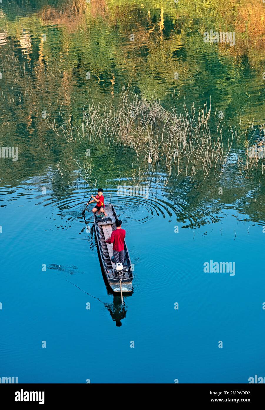 Boys fishing on Vajiralongkorn Lake, Sangkhlaburi, Thailand Stock Photo