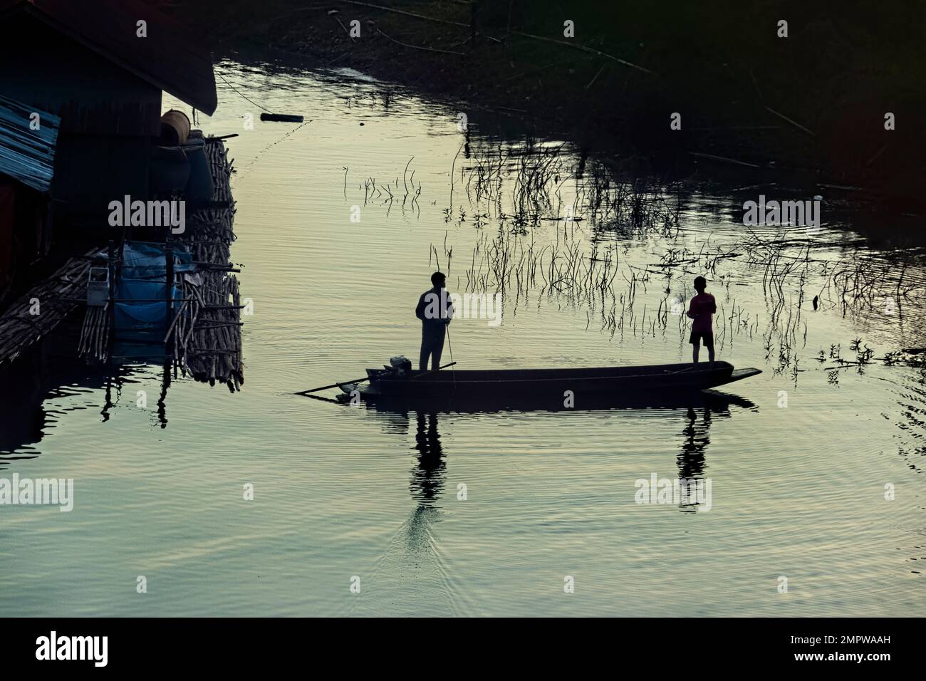 Boys fishing on Vajiralongkorn Lake, Sangkhlaburi, Thailand Stock Photo