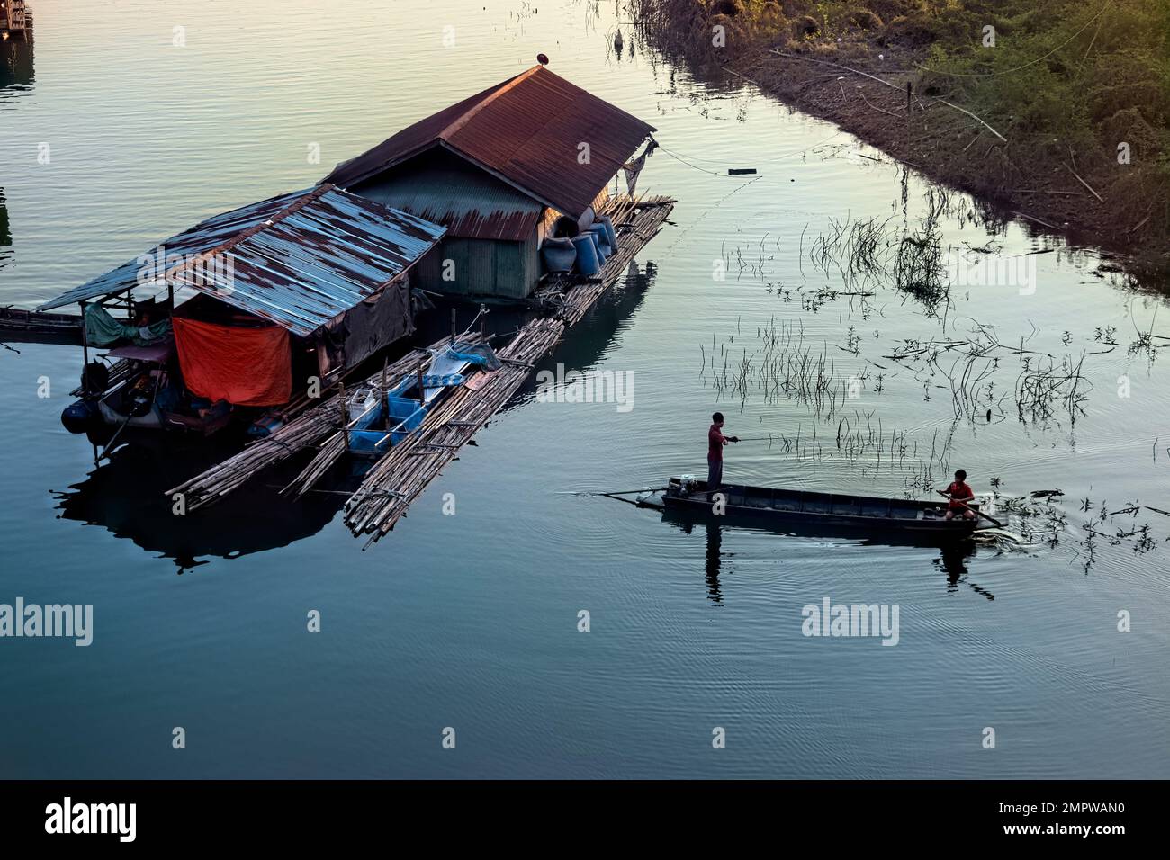 Boys fishing on Vajiralongkorn Lake, Sangkhlaburi, Thailand Stock Photo