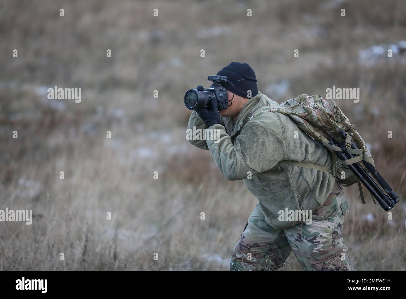 U.S. Army Sgt. Gavin Ching, a mass communication specialist assigned to 117th Mobile Public Affairs Department (117th MPAD), operationally controlled by the 1st Infantry Division (1 ID), takes photos of Soldiers during a live fire exercise rehearsal at Bemowo Piskie Training Area, Poland, Nov. 18, 2022. The 117th MPAD is among other units assigned to the 1 ID, proudly working alongside NATO allies and regional security partners to provide combat-credible forces to V Corps, America's forward deployed corps in Europe. Stock Photo