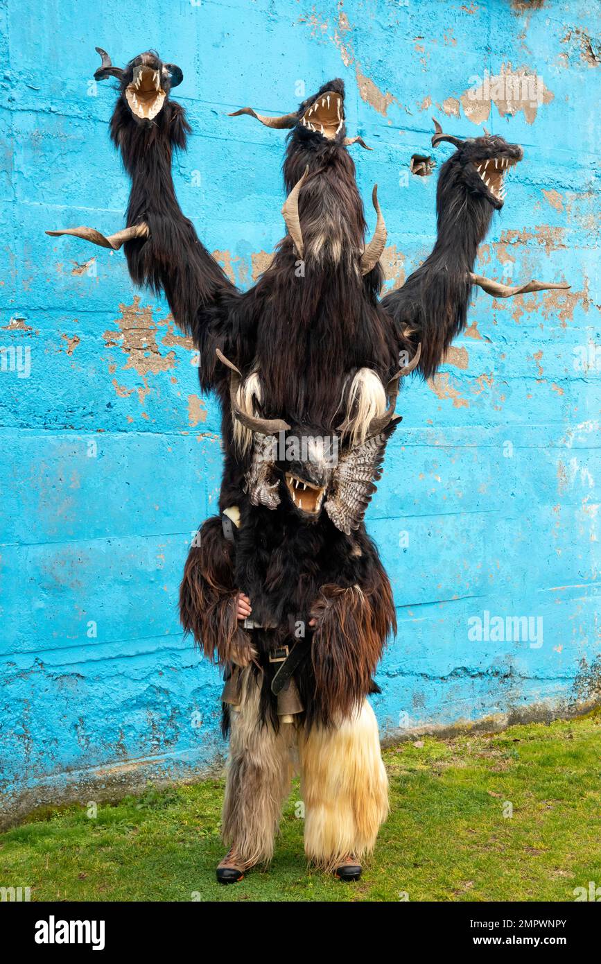 Mummer Kukeri dancer with bizarre costume depicting three-headed monster at the annual Simitlia Kukeri festival in Simitli, Bulgaria, Eastern Europe Stock Photo