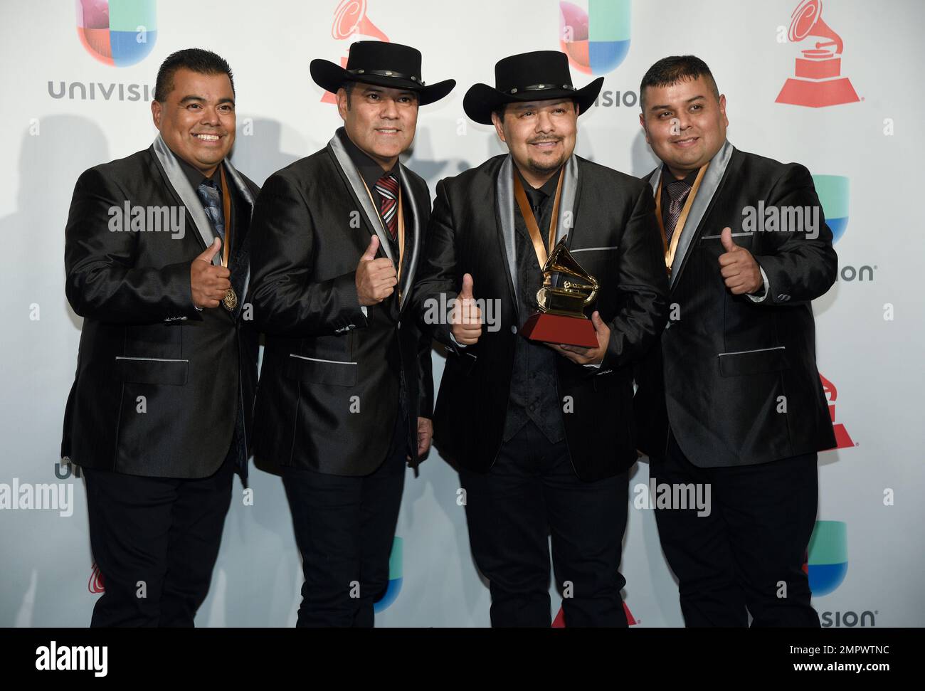 Los Palominos pose in the press room with the award for best norteno ...