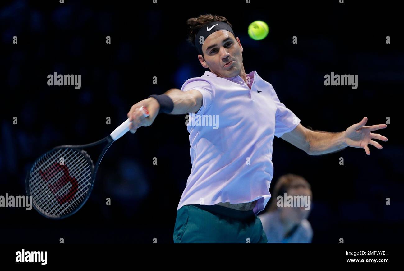 Roger Federer of Switzerland plays a return to Marin Cilic of Croatia during their mens singles match at the ATP World Finals at the O2 Arena in London, Thursday, Nov
