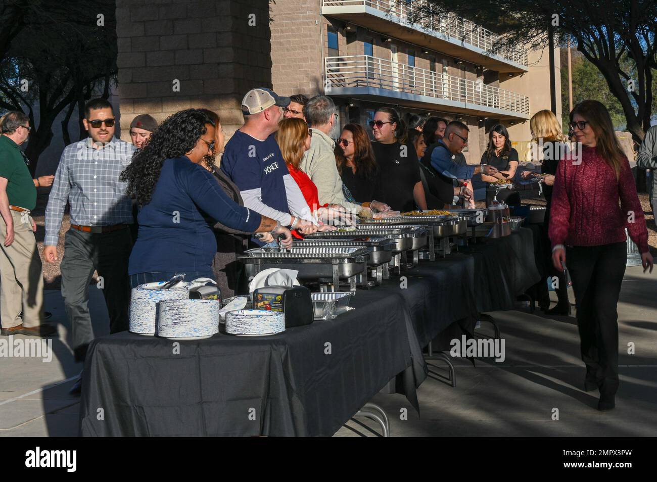 Volunteers serve a holiday meal during a dorm bash celebration at Davis