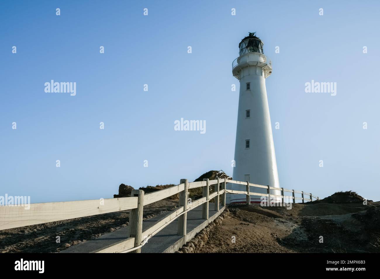Path and railing leading to Castle Point Lighthouse and coastline on Wairarapa coast in New Zealand. Stock Photo
