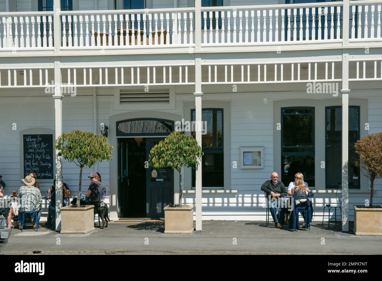 Martinborough New Zealand October 4 2010;  People sitting outside enjoying sun and Martinborough Hotel hospitality Stock Photo