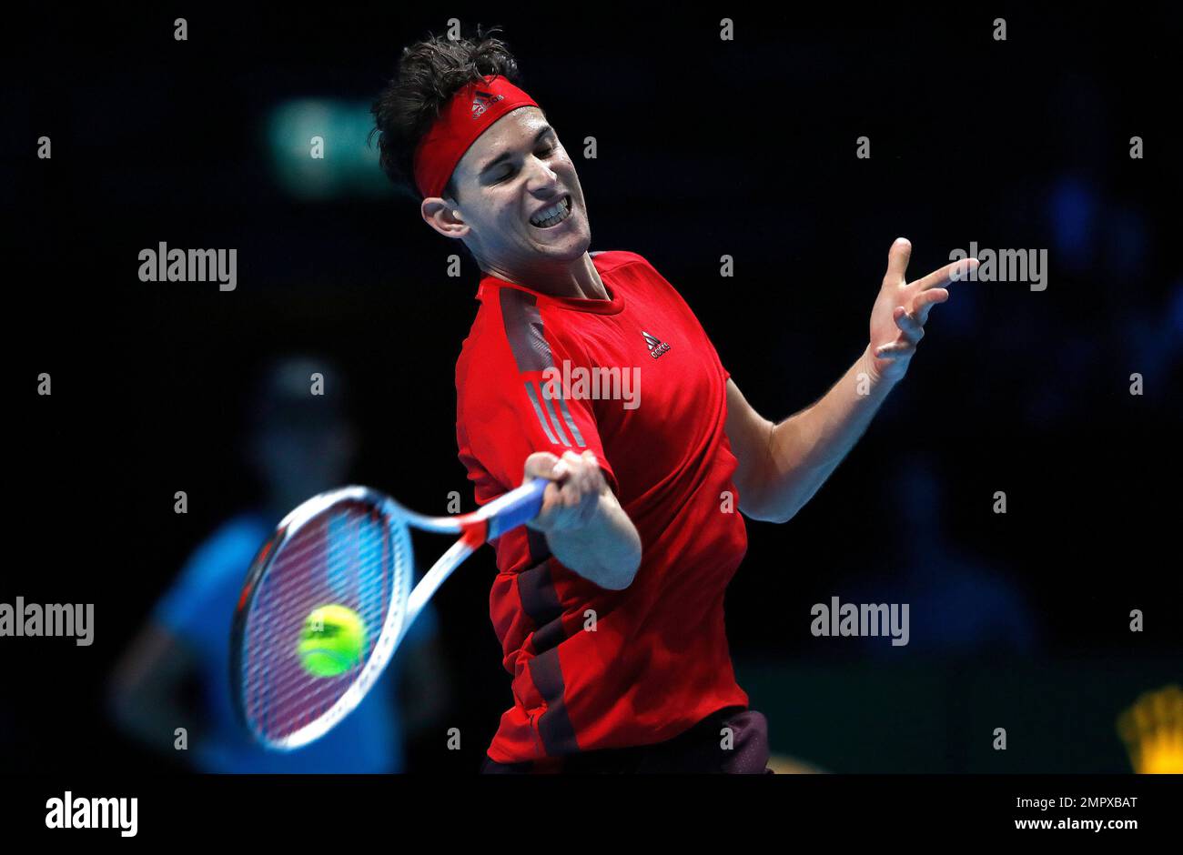 Dominic Thiem of Austria returns to Pablo Carreno Busta of Spain during their singles tennis match at the ATP World Finals at the O2 Arena in London, Wednesday, Nov